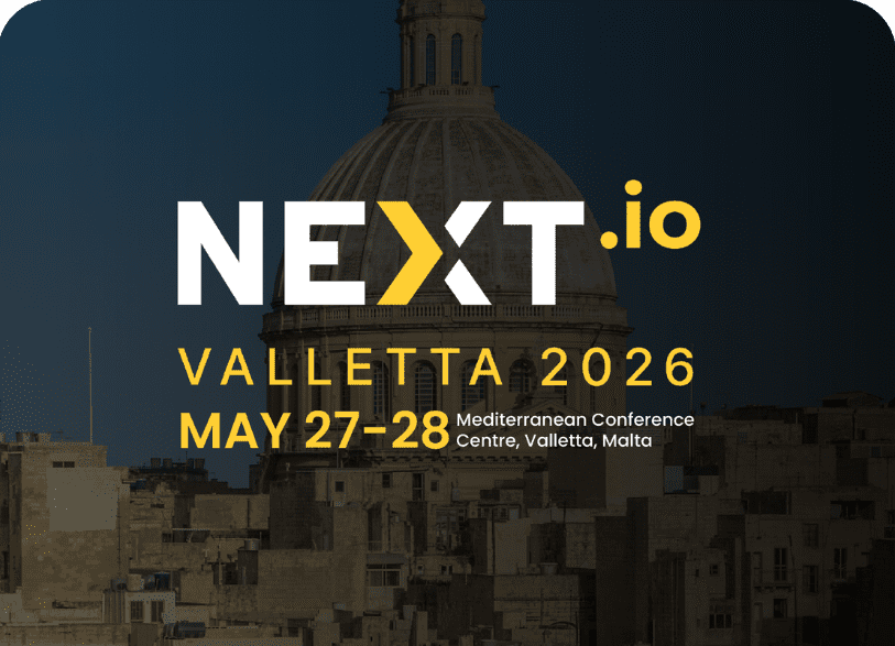 Gaming Associates exhibition booth at NEXT.io conference in Valletta, Malta, May 28–29. iGaming industry summit banner with company logo and compliance focus.